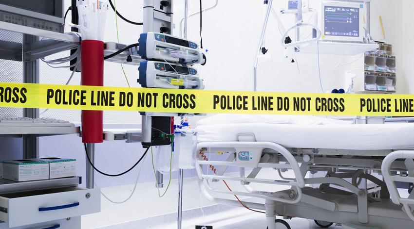 Police line tape across an emergency department room