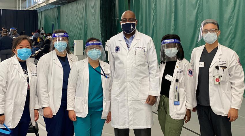 Medical student volunteers from Howard University College of Medicine pose with Dean Hugh Mighty, MD, MBA, at a community vaccination clinic in Washington, DC, on April 3, 2021.