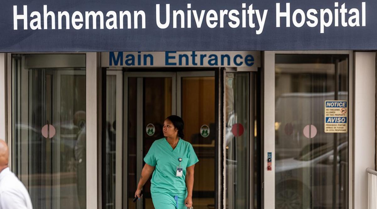 A health care worker exits Hahnemann University Hospital on July 9, 2019. (Christopher Evens/Alamy Stock Photo)