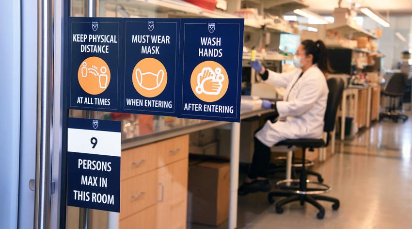 A researcher in a lab at Emory University works under new rules on social distancing and sanitation