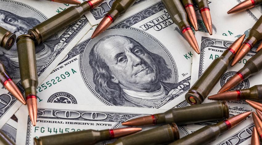 Hundred dollar bills and machine gun cartridges