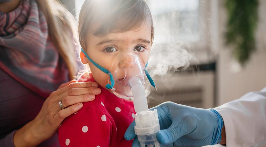 Asthma, little girl with inhaling mask