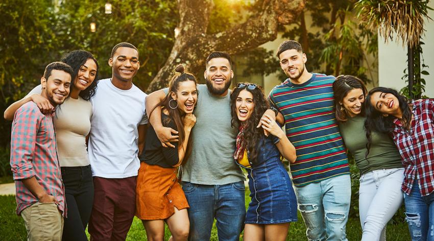 Portrait of cheerful friends. Young multi-ethnic males and females are wearing casuals. They are enjoying in party at back yard.