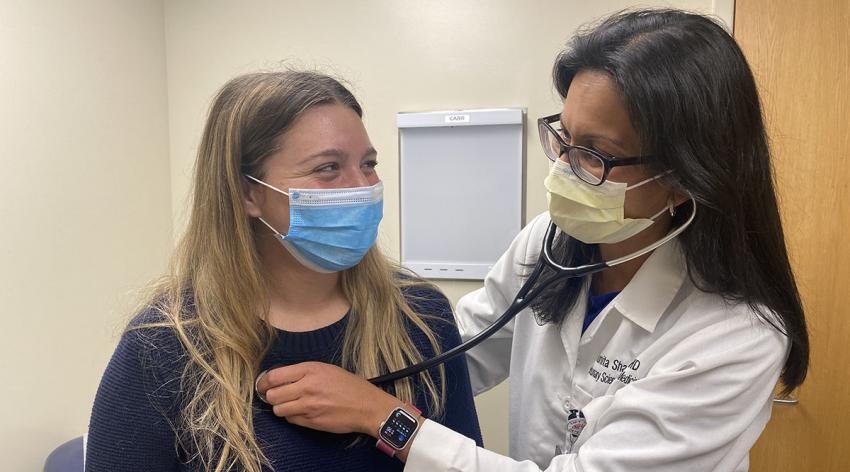 Sunita Sharma, MD, a pulmonologist at UC Health in Aurora, Colorado, with a patient.