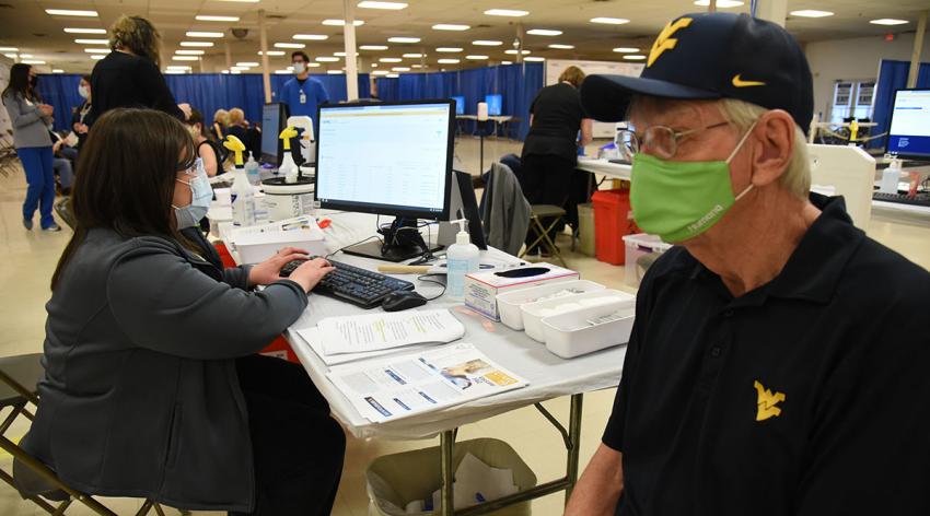 A West Virginia resident is vaccinated on January 25, 2021, at the WVU Medicine and Monongalia County vaccine clinic.