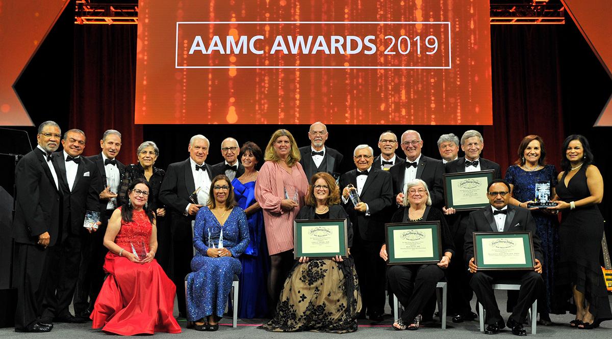 A large group of people under a sign that says "AAMC Awards 2019"