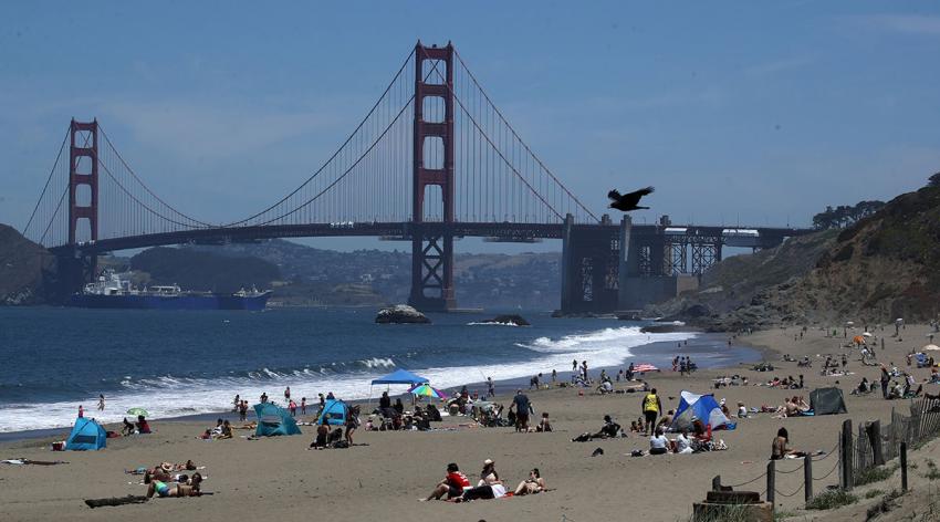 People sit on the beach at Baker Beach on May 26, 2020 in San Francisco, California. Beaches across the state have seen large crowds as they have started to slowly reopen.