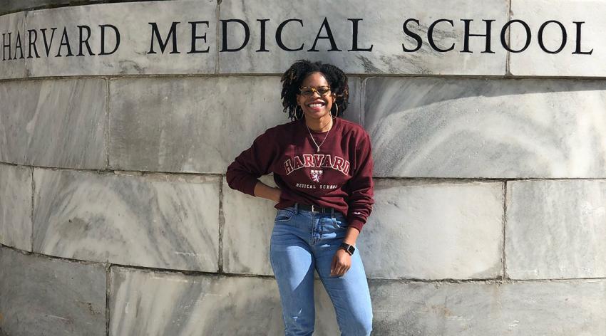 LaShyra Nolen, a first-year medical student at Harvard Medical School, poses in front of the school