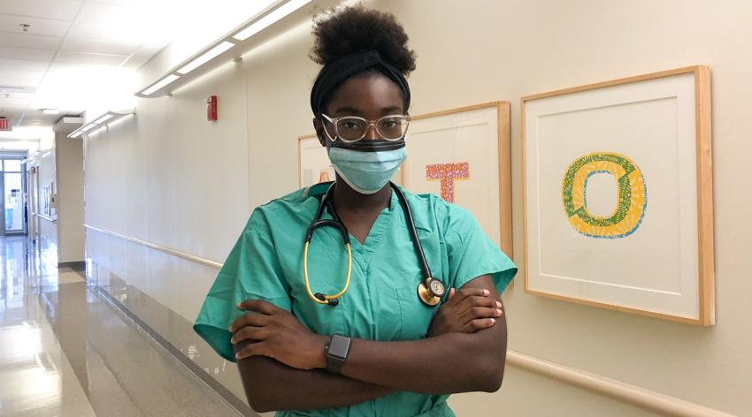 Christle Nwora, MD, dons personal protective equipment for her residency at Johns Hopkins Medicine