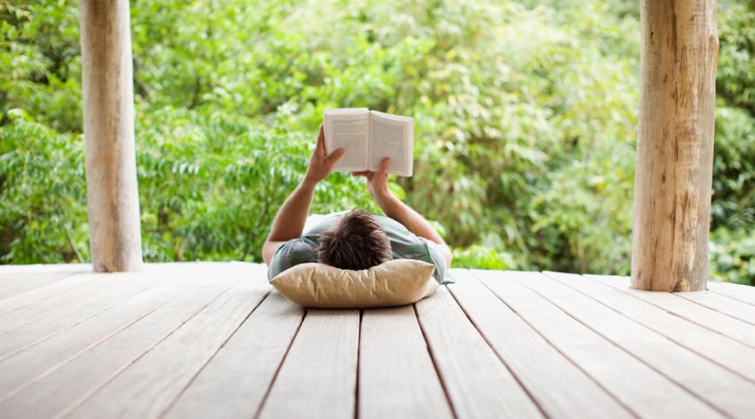 Man reading on porch in remote area